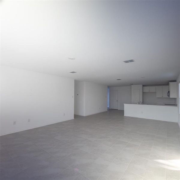 Unfurnished living room with light tile patterned floors