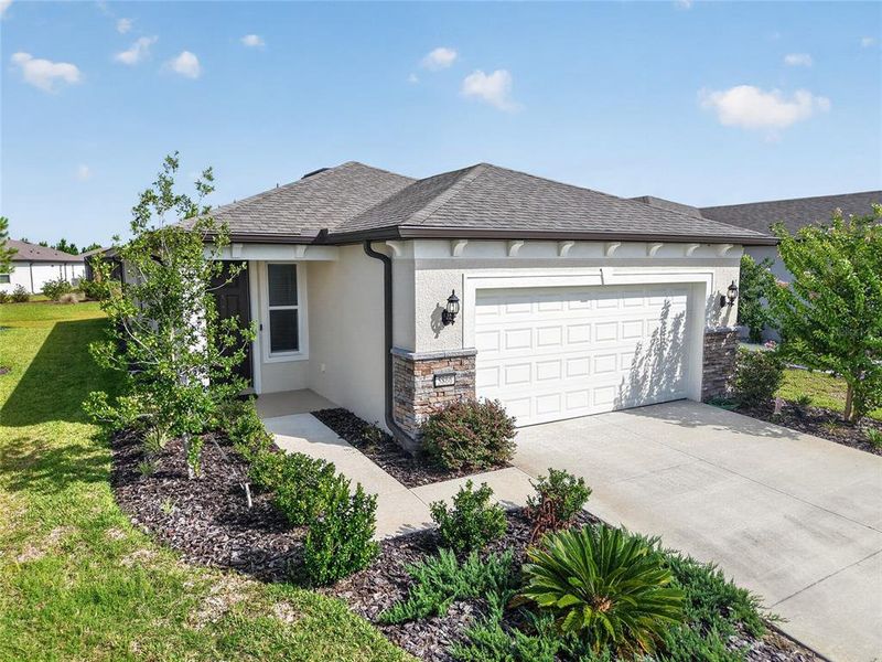 Front exterior of a new home in Del Webb Stone Creek, Ocala, FL, highlighting curb appeal (Image 24).