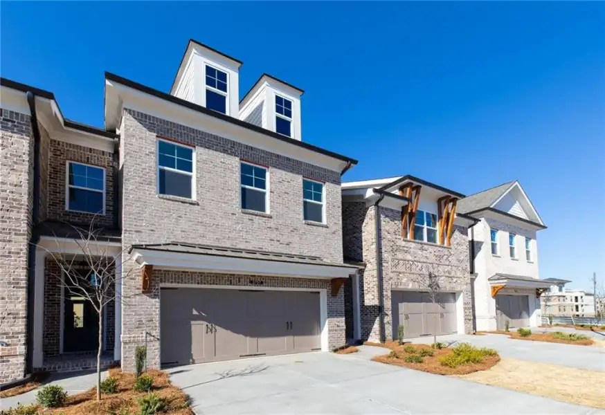 Front exterior of a new home in Oakcrest, Duluth, GA, highlighting curb appeal (Image 2). Front exterior of a new home in Oakcrest, Duluth, GA, highlighting curb appeal (Image 2).