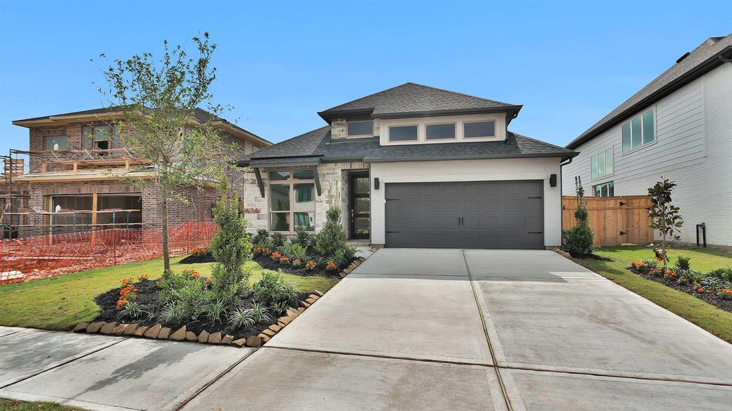 Front exterior of a new home in Cross Creek West, Fulshear, TX, highlighting curb appeal (Image 11). Front exterior of a new home in Cross Creek West, Fulshear, TX, highlighting curb appeal (Image 11).