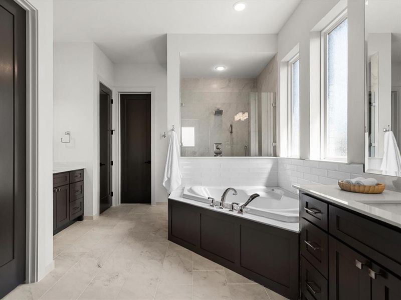 Full bath featuring a stall shower, a bath, vanity, and recessed lighting Full bath featuring a stall shower, a bath, vanity, and recessed lighting