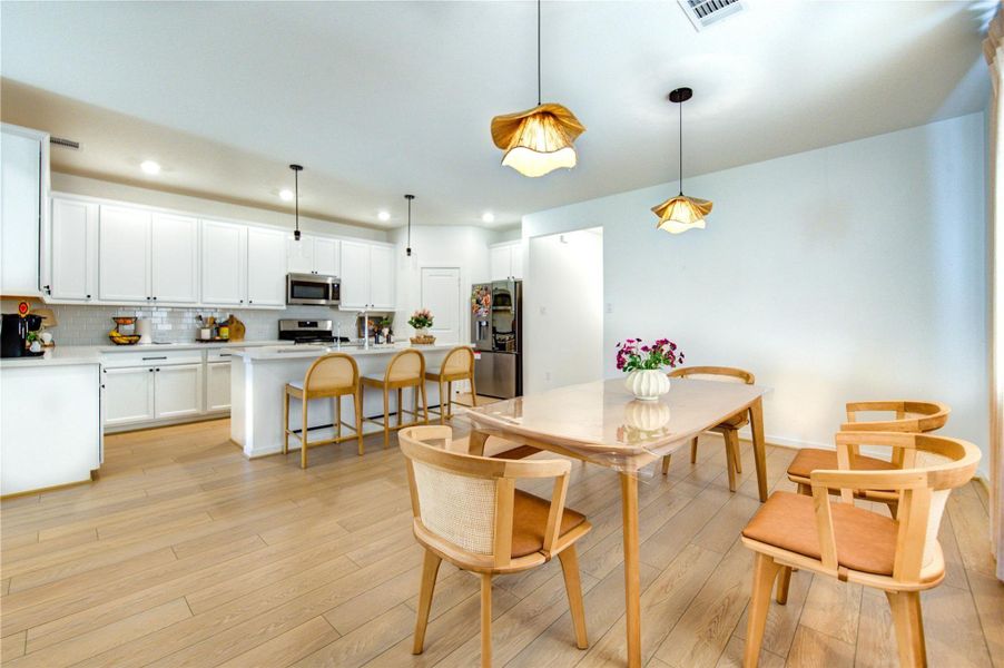 Fabulous open-concept layout for today's lifestyle... From this vantage point you'll enjoy a clear view of the perfected connection between the dining area and gourmet kitchen creating an ideal setting for effortless, free-flowing entertaining.