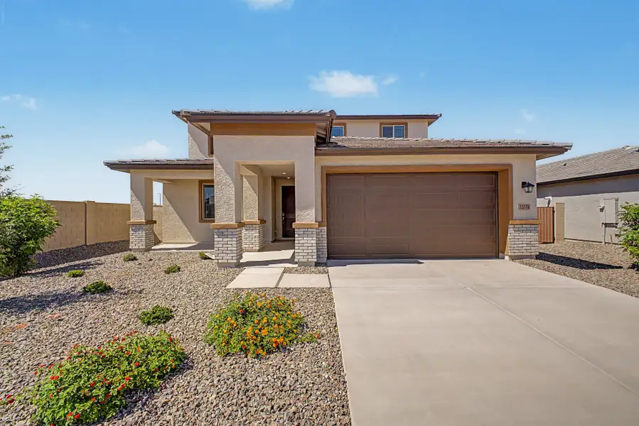 Front exterior of a new home in Windstone Ranch North, Surprise, AZ, highlighting curb appeal (Image 1). Front exterior of a new home in Windstone Ranch North, Surprise, AZ, highlighting curb appeal (Image 1).
