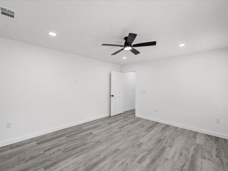 Spare room featuring light wood-type flooring, recessed lighting, and ceiling fan