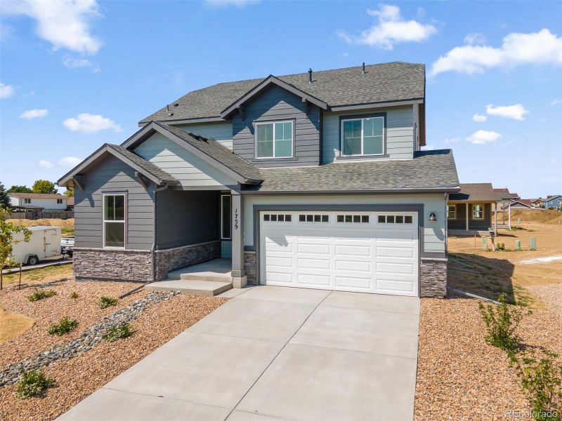 Front exterior of a new home in Cherry Meadows, Brighton, CO, highlighting curb appeal (Image 22). Front exterior of a new home in Cherry Meadows, Brighton, CO, highlighting curb appeal (Image 22).