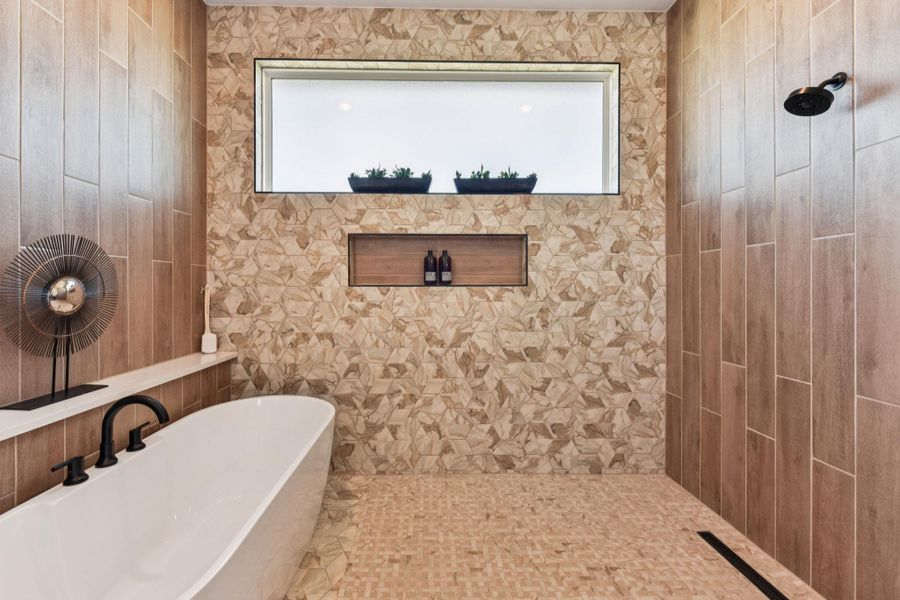 Full bath with a freestanding bath and a tile shower