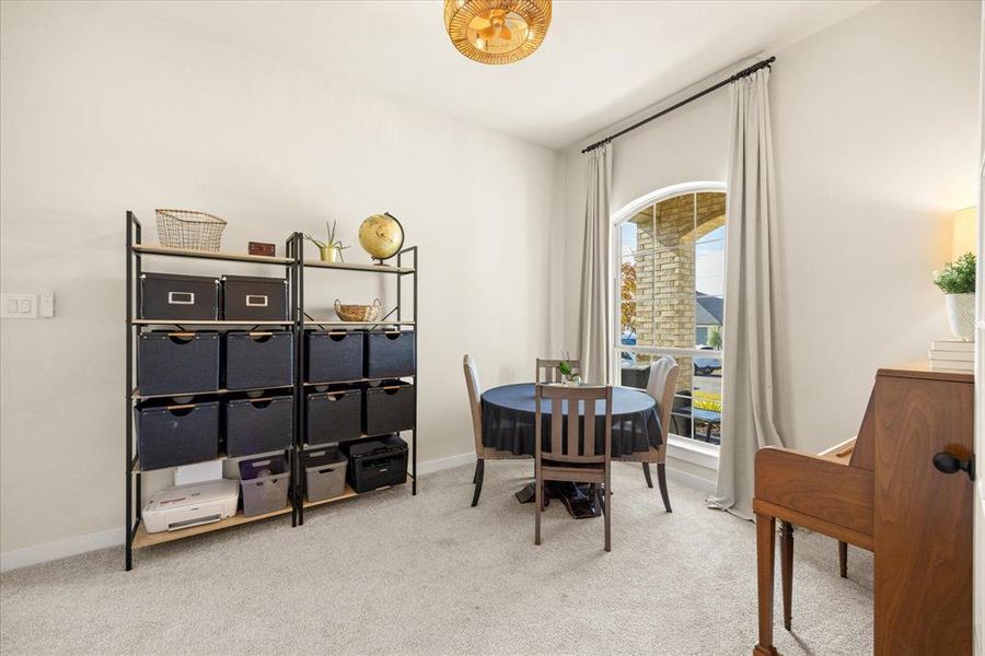 Dining area featuring light colored carpet and baseboards
