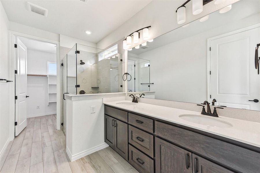 Bathroom with a sink, visible vents, double vanity, and a stall shower Bathroom with a sink, visible vents, double vanity, and a stall shower