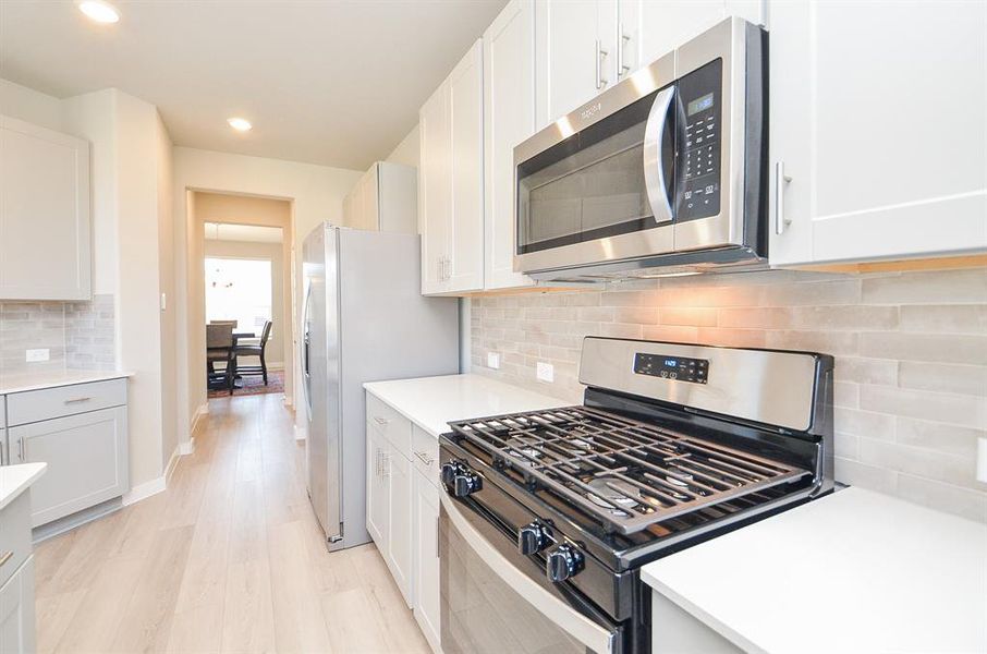 Convenient accessibility from kitchen to dining is offered in this modern design.