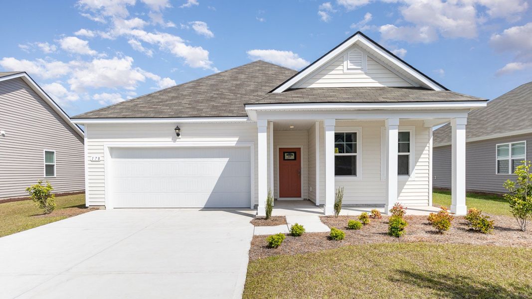Front exterior of a new home in Winfield Farms, Myrtle Beach, SC, highlighting curb appeal (Image 1). Front exterior of a new home in Winfield Farms, Myrtle Beach, SC, highlighting curb appeal (Image 1).