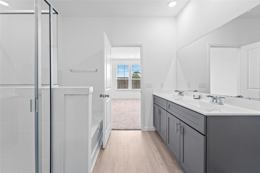 another view of primary bathroom with separate tub and shower