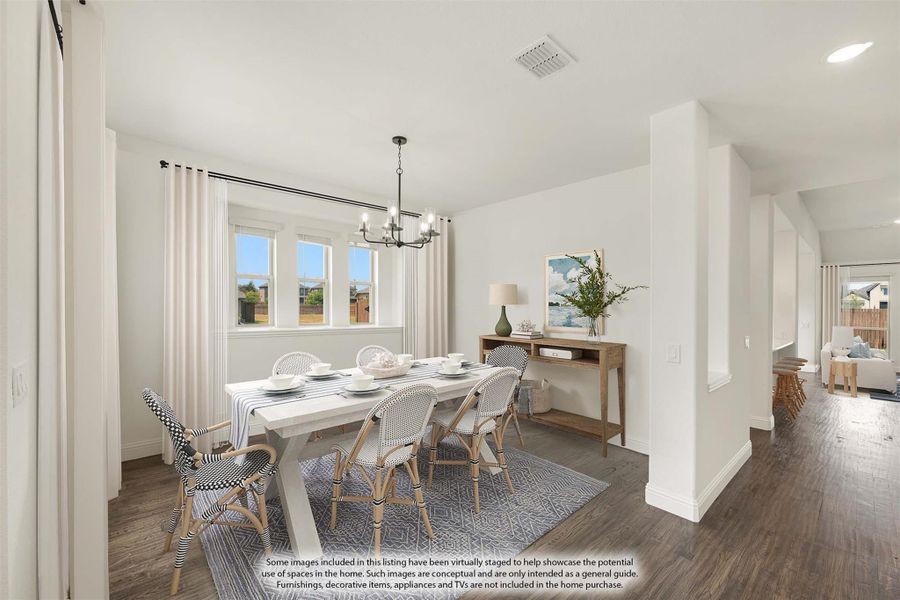 Dining room with white table, six chairs, chandelier, and dark hardwood floors