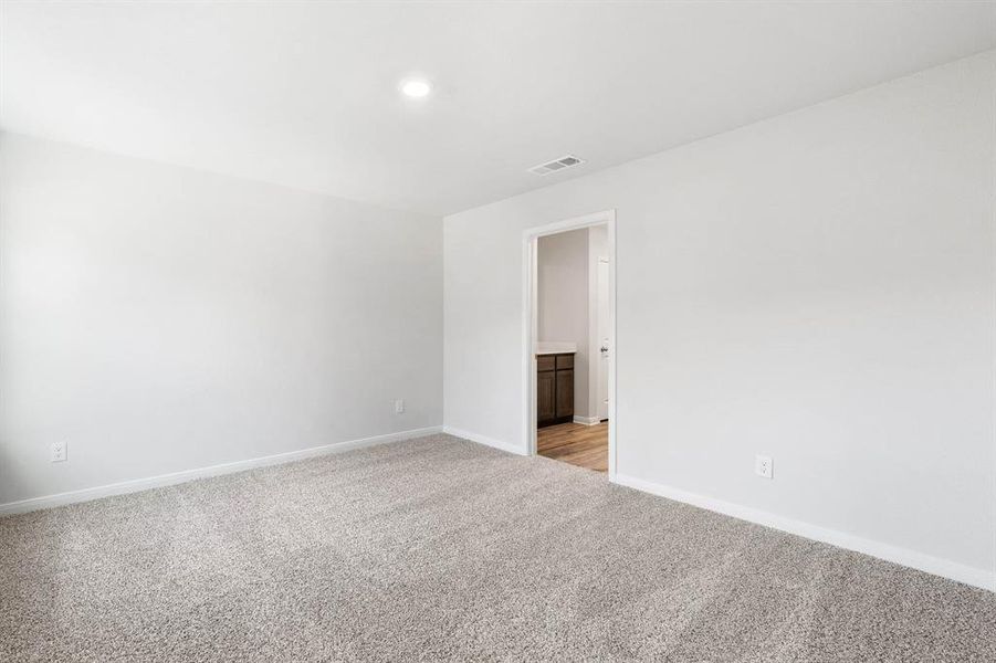 Empty room featuring light carpet