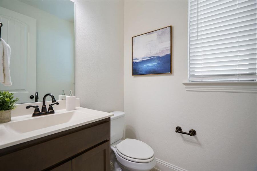 The half bath is right where you need it — perfectly placed in the center of the home for easy access.