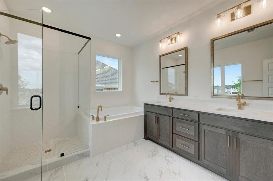 Spacious bathroom featuring a glass-enclosed shower, a separate soaking tub, and a dual vanity with undermount sinks