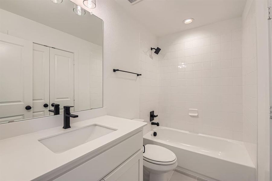 Full bathroom with vanity, toilet, shower combination, and recessed lighting Full bathroom with vanity, toilet, shower combination, and recessed lighting