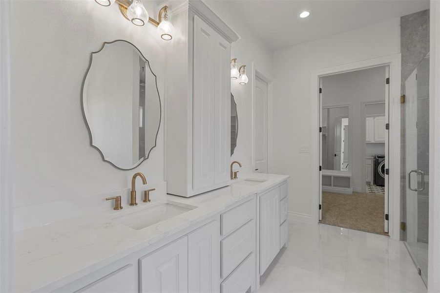 Bathroom with vanity and washer / dryer