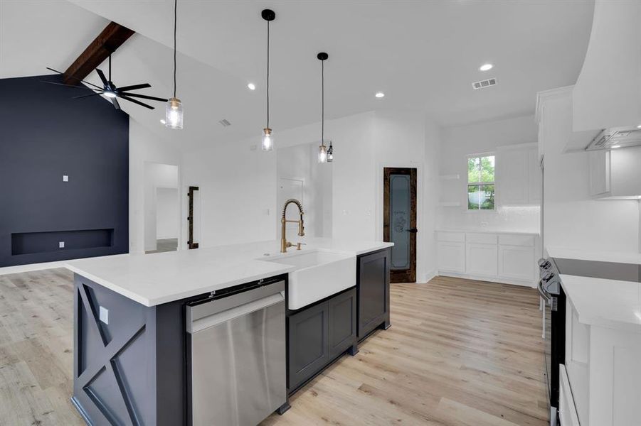 Kitchen featuring light wood-type flooring, a center island with sink, stainless steel appliances, premium range hood, and ceiling fan