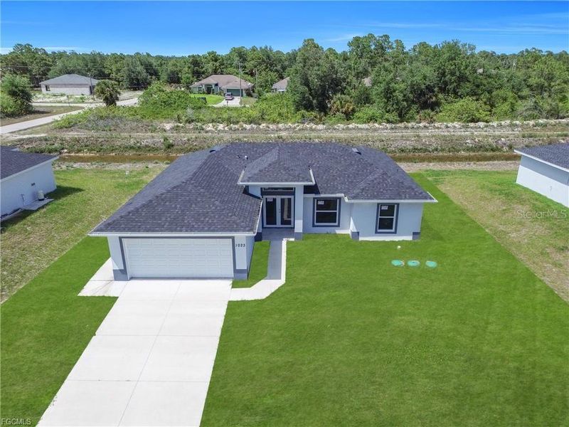 Front exterior of a new home in , Lehigh Acres, FL, highlighting curb appeal (Image 19).