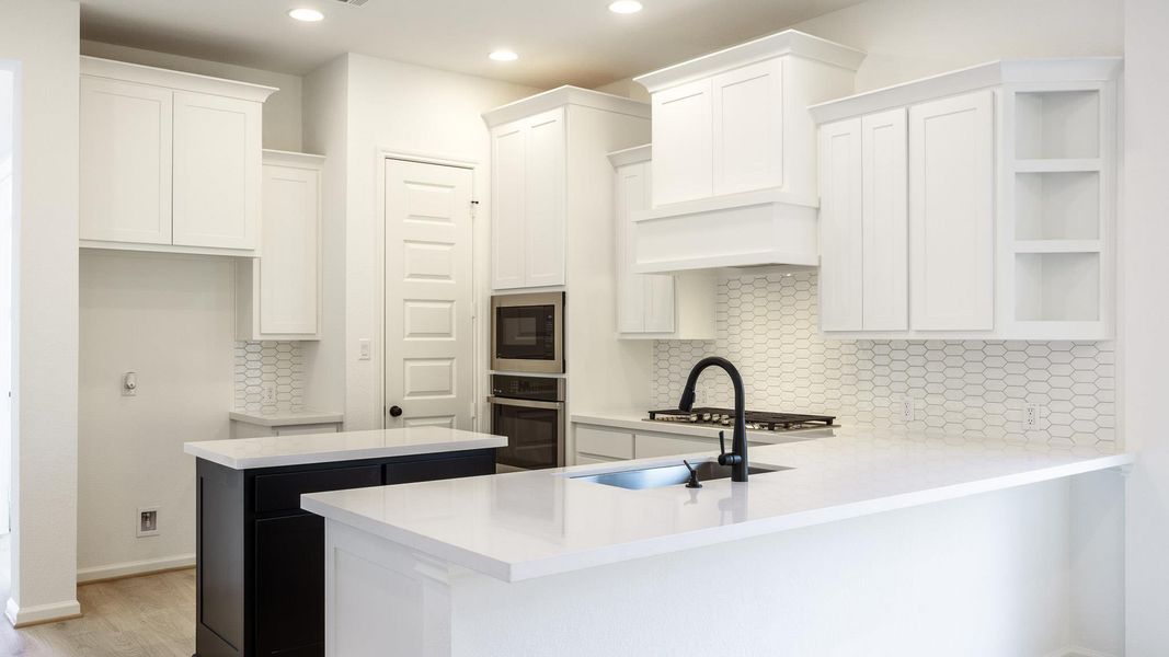Kitchen featuring white cabinets, a center island, decorative backsplash, open shelves, and recessed lighting Kitchen featuring white cabinets, a center island, decorative backsplash, open shelves, and recessed lighting