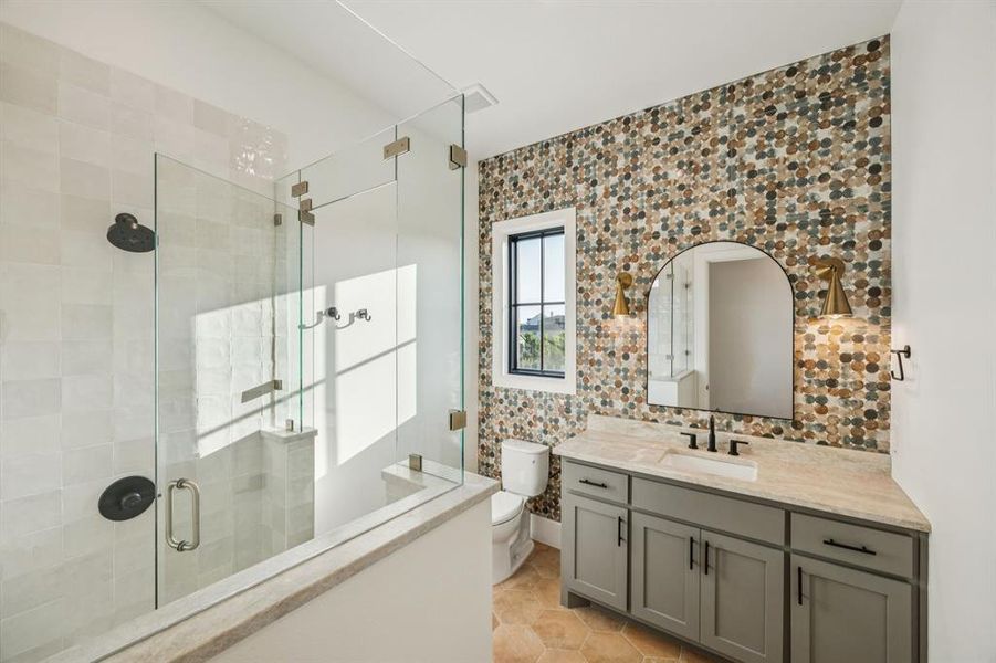 Full bath featuring vanity, a stall shower, and backsplash Full bath featuring vanity, a stall shower, and backsplash