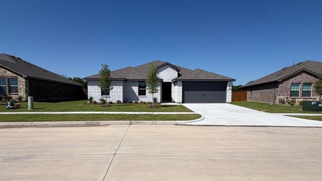Single-story residence featuring a light-colored brick exterior facade, a dark gray garage door, and a matching dark gray shingle roof Single-story residence featuring a light-colored brick exterior facade, a dark gray garage door, and a matching dark gray shingle roof