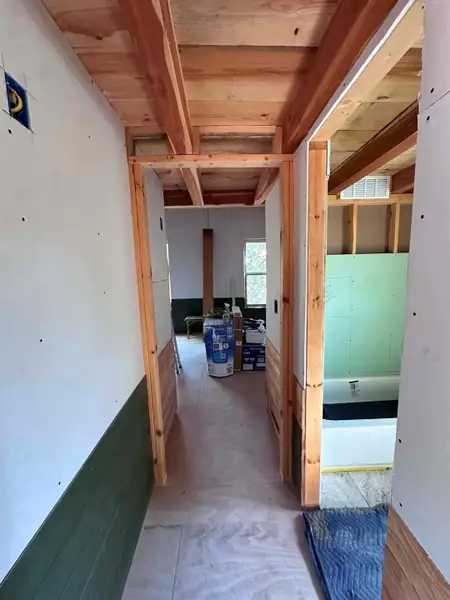A well-lit hallway awaits completion, offering a glimpse into future design possibilities.