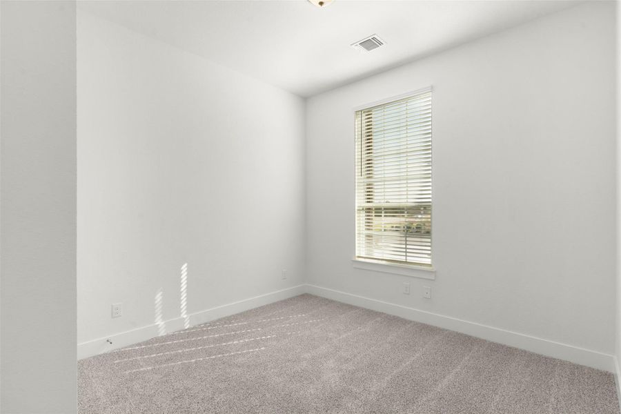 Carpeted empty room featuring baseboards