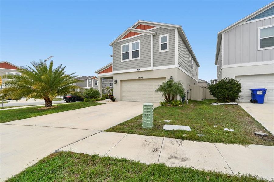 Front exterior of a new home in Pasadena Point, Wesley Chapel, FL, highlighting curb appeal (Image 22).