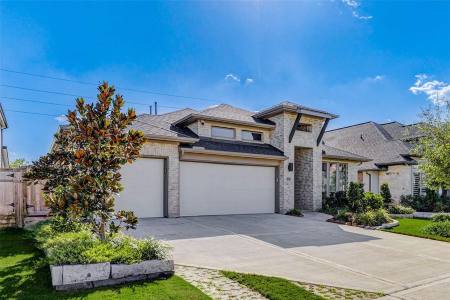Front exterior of a new home in Cross Creek West 55', Fulshear, TX, highlighting curb appeal (Image 22).