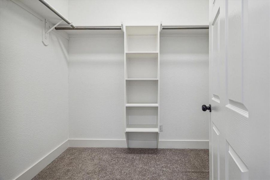 Primary closet with built in shelving.