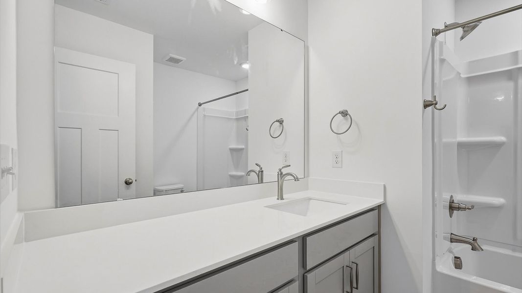 Accomplished full bath designed with both comfort and sophistication in mind by DRB Homes Accomplished full bath designed with both comfort and sophistication in mind by DRB Homes