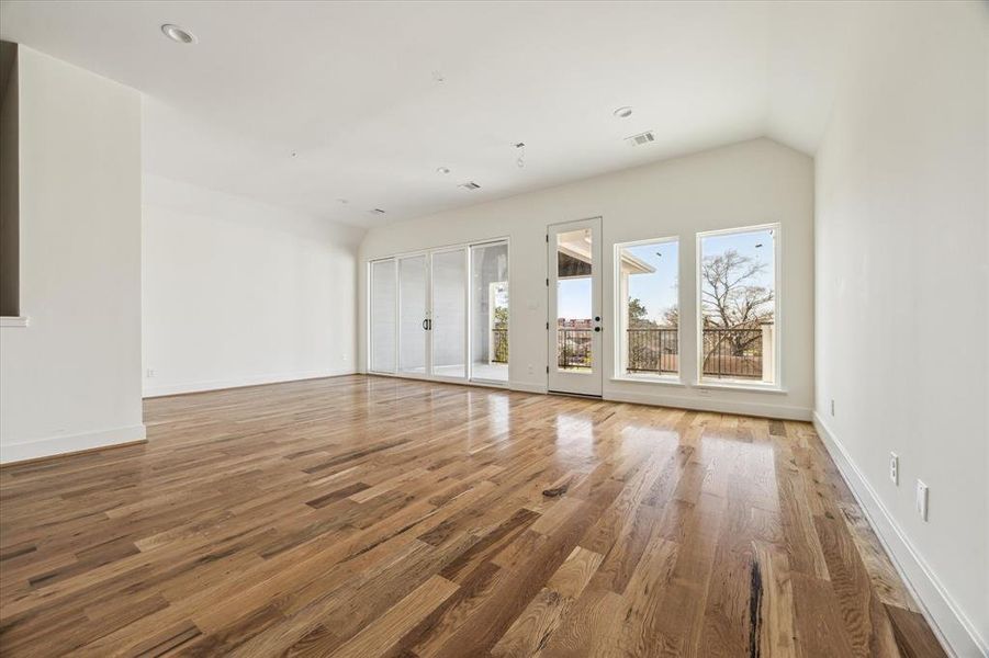 Large game/play room with sliding doors to covered patios.  The room can be  divided for a 4th bedroom for future use or be enjoyed as one big room!