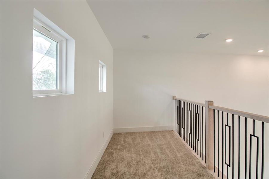Corridor with light carpet and recessed lighting Corridor with light carpet and recessed lighting
