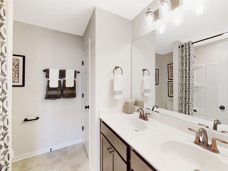 A bathroom with a large mirror.