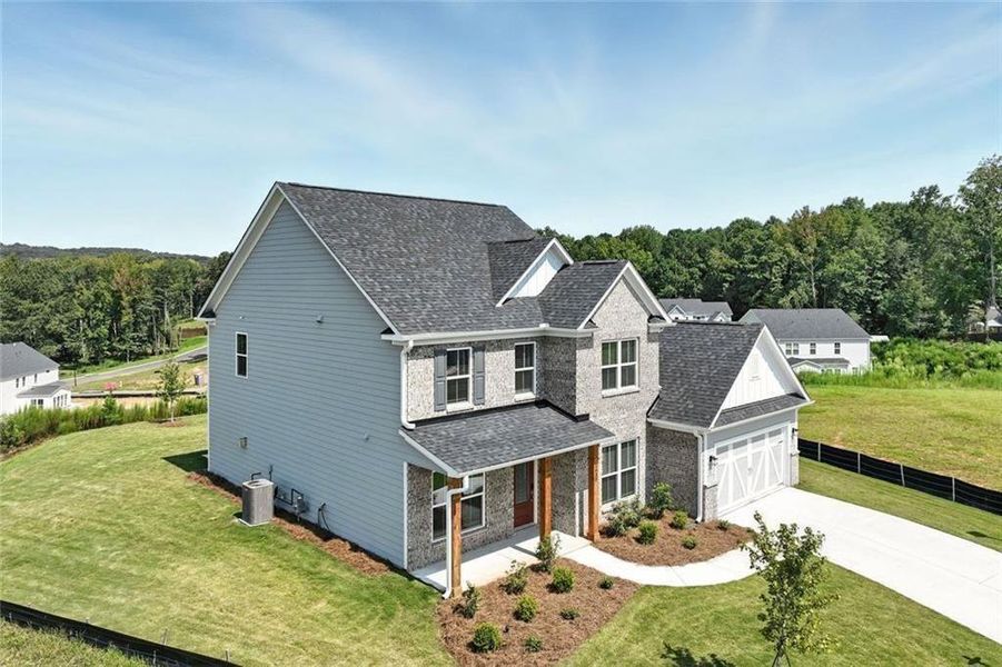 Front exterior of a new home in Berkeley Mill, Cumming, GA, highlighting curb appeal (Image 26). Front exterior of a new home in Berkeley Mill, Cumming, GA, highlighting curb appeal (Image 26).