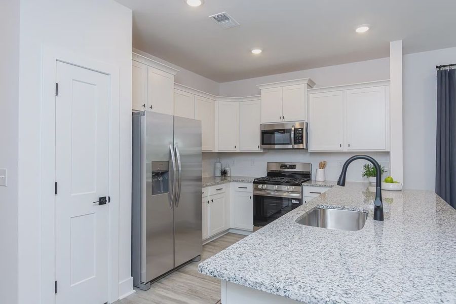 Representative furnished interior of a home built from the 1557 Townhome by Adams Homes in Parkstone Place Townhomes, Roebuck (Image 6).