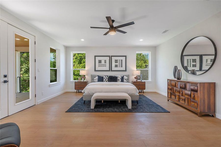 Bedroom featuring light hardwood / wood-style floors, access to outside, and ceiling fan