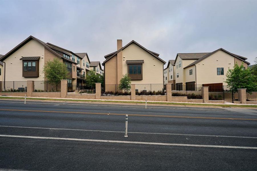 Modern multi-story residences featuring light-toned siding and dark pitched roofs Modern multi-story residences featuring light-toned siding and dark pitched roofs