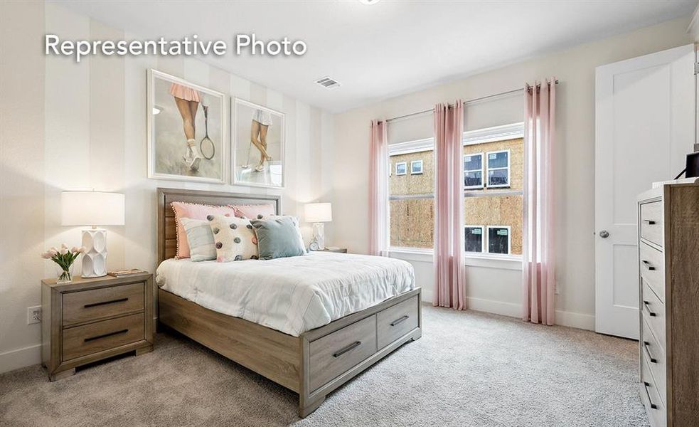 Bedroom with light colored carpet