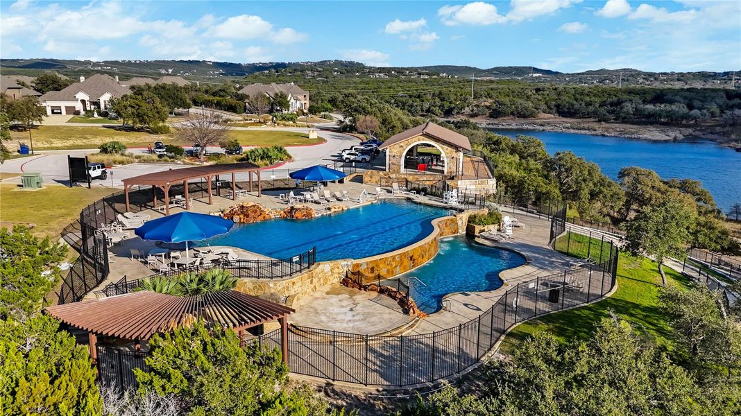 An inviting community swimming pool overlooks rolling green hills and a tranquil waterfront view. An inviting community swimming pool overlooks rolling green hills and a tranquil waterfront view.