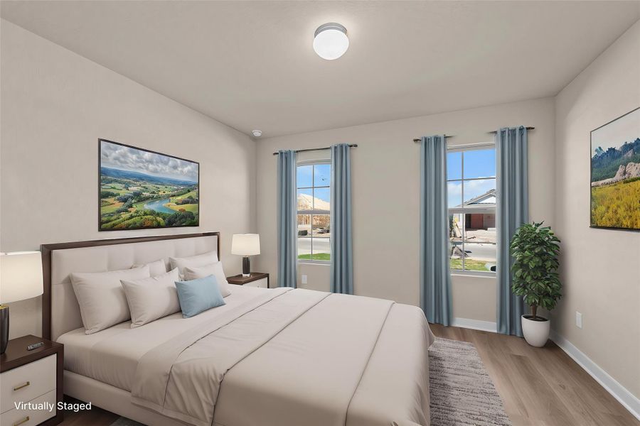 Well-lit sleeping quarters with natural wood-tone flooring and twin windows offering pleasant neighborhood views.