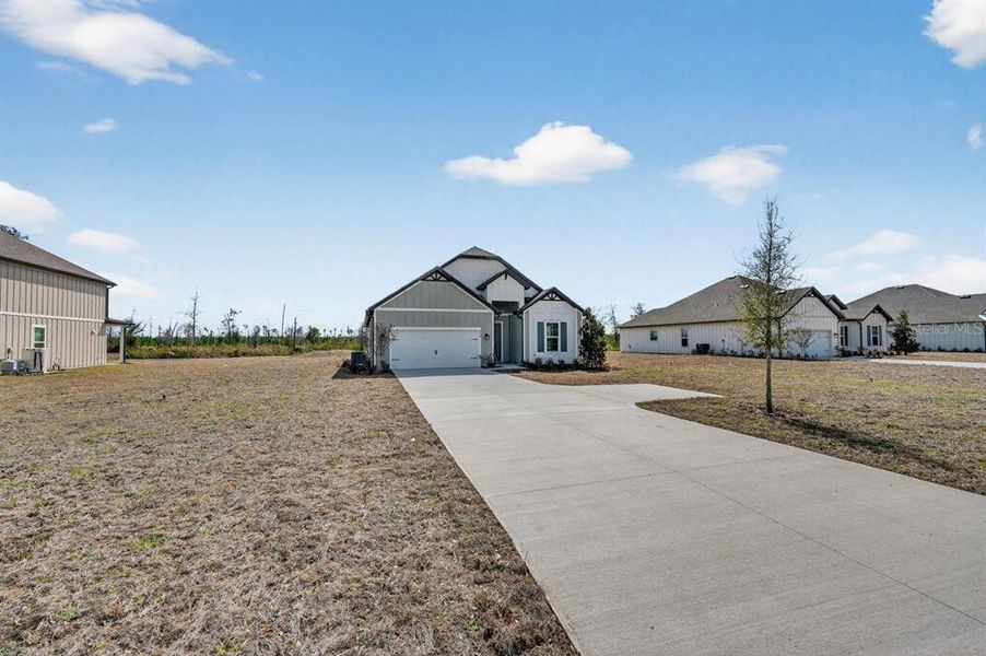 Front exterior of a new home in Stables at Cary Forest, Bryceville, FL, highlighting curb appeal (Image 24).