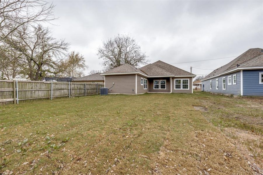 Back of property with a patio and roof with shingles