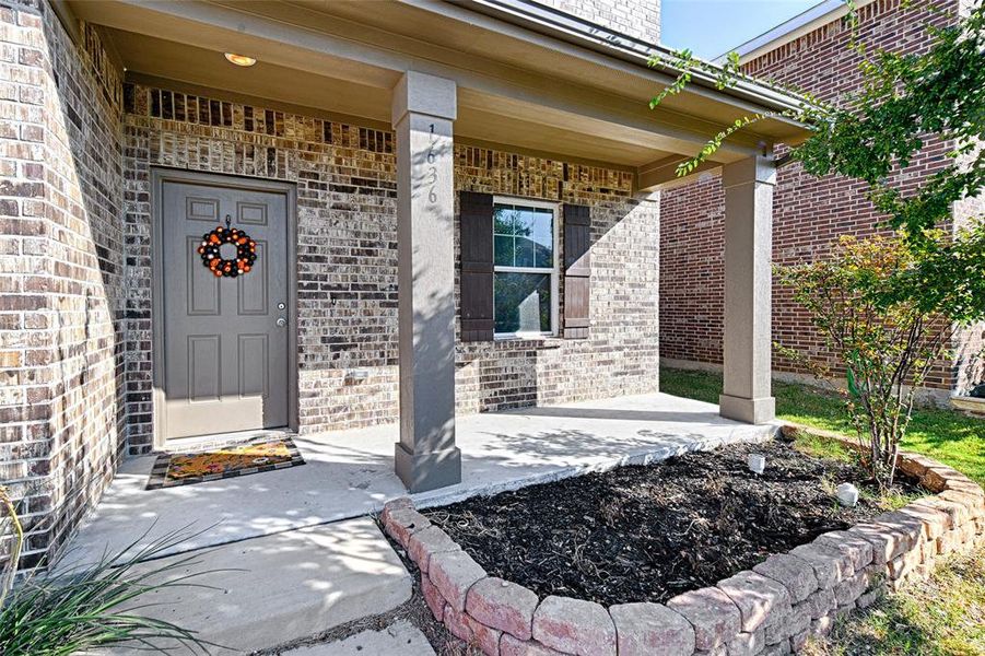 Property entrance with brick siding and covered porch Property entrance with brick siding and covered porch