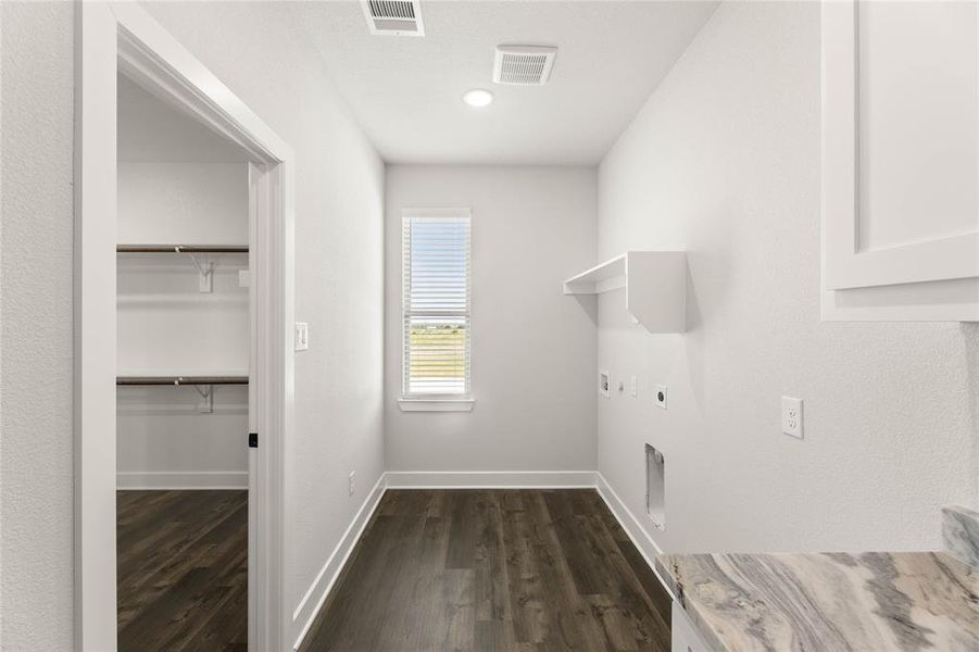 Laundry room featuring dark wood finished floors, electric dryer hookup, and washer hookup Laundry room featuring dark wood finished floors, electric dryer hookup, and washer hookup