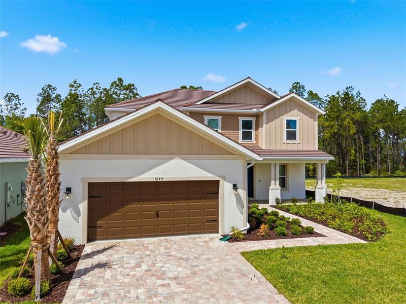 Front exterior of a new home in Hammock at Two Rivers, Zephyrhills, FL, highlighting curb appeal (Image 28).