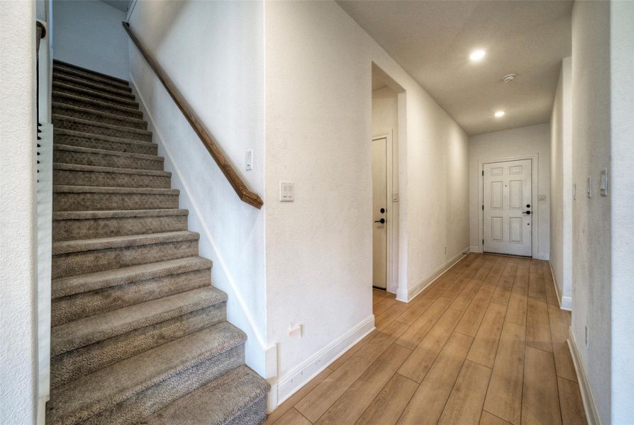 Hardwood floors and recessed lighting welcome guests inside this inviting entry hall. Hardwood floors and recessed lighting welcome guests inside this inviting entry hall.