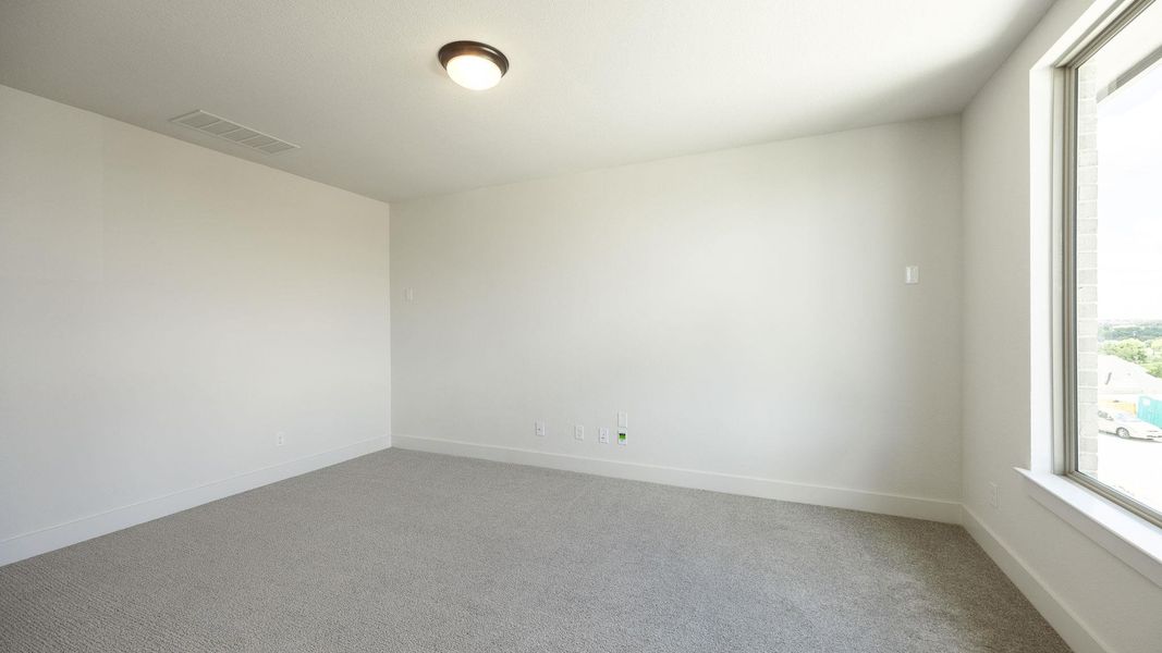Carpeted empty room featuring baseboards