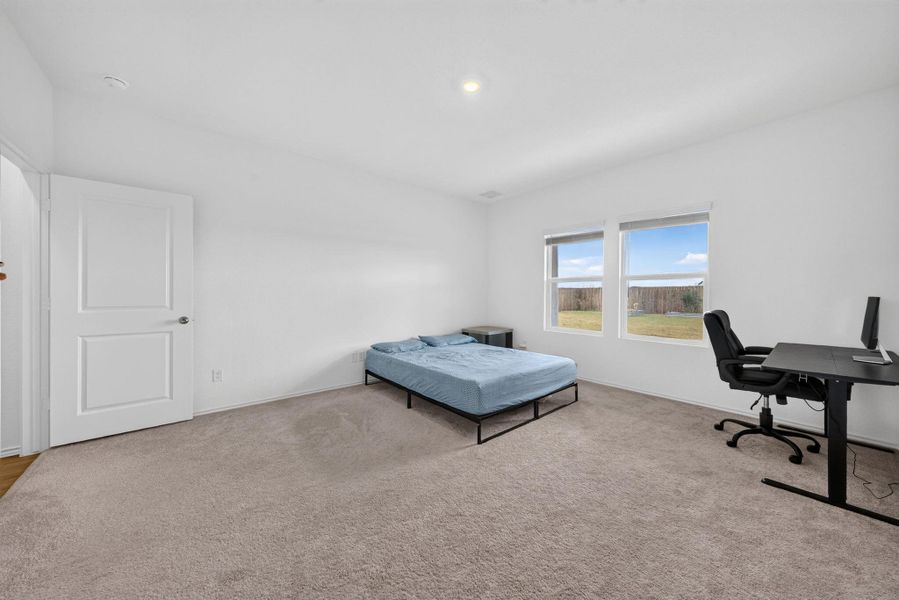 A well-lit bedroom features ample natural light and plush carpeting, offering a comfortable retreat. A well-lit bedroom features ample natural light and plush carpeting, offering a comfortable retreat.